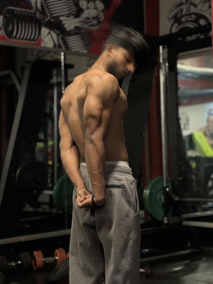Vaibhav in the gym, posing side-on